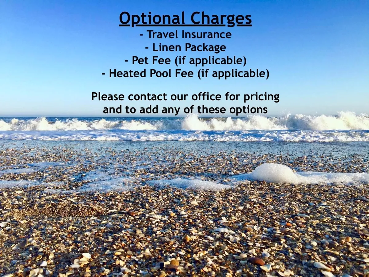 A wide beachfront view featuring waves rolling onto sandy shores under a peaceful sky. Shells dot the beach, and the open space invites exploration, swimming, and sunset walks.